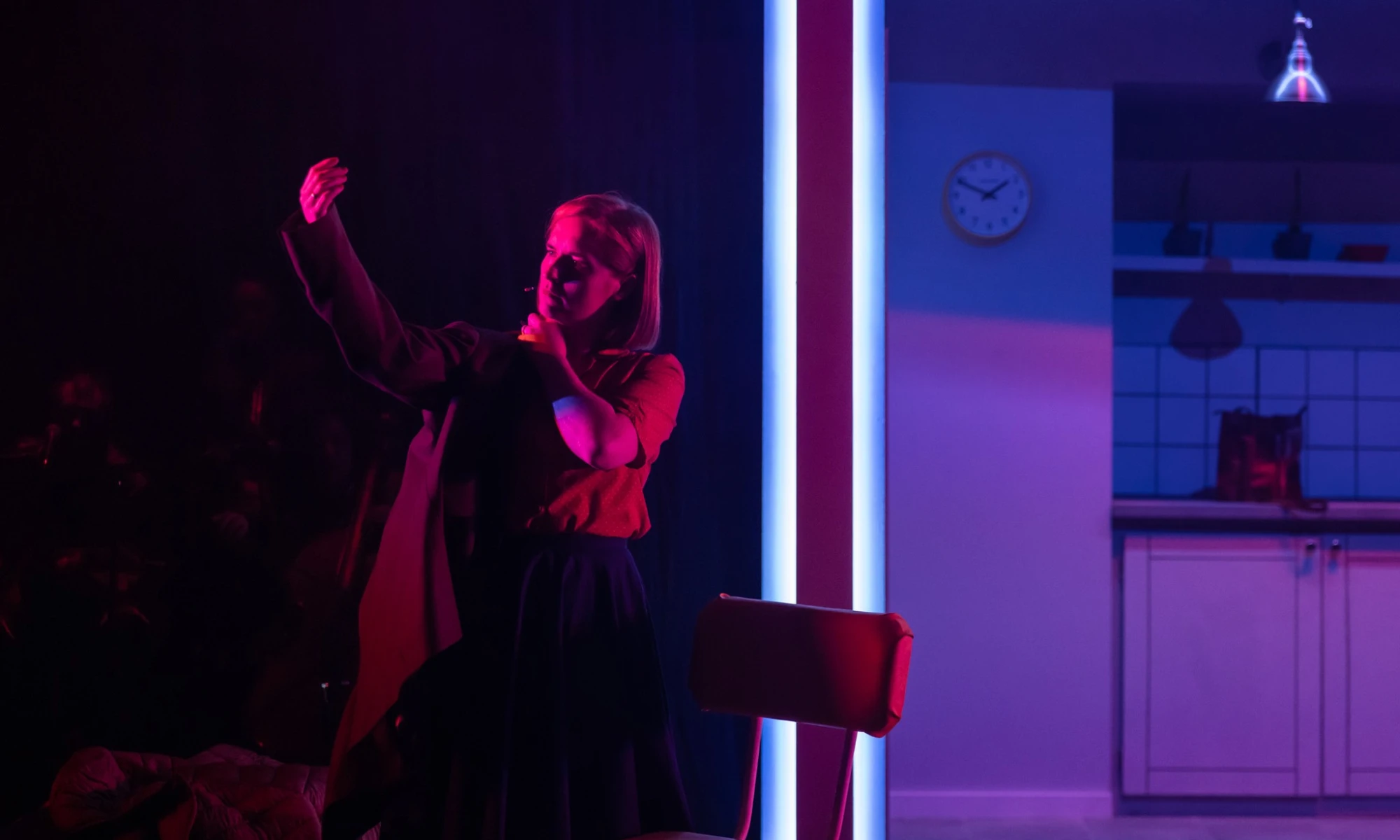 Photo of actor on stage in performance of Everything Falls. 