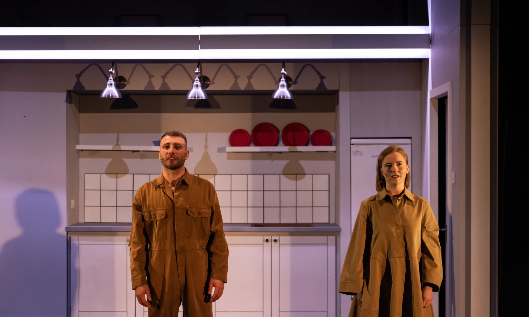 Photo of two actors on set for theatre performance of Everything Falls.