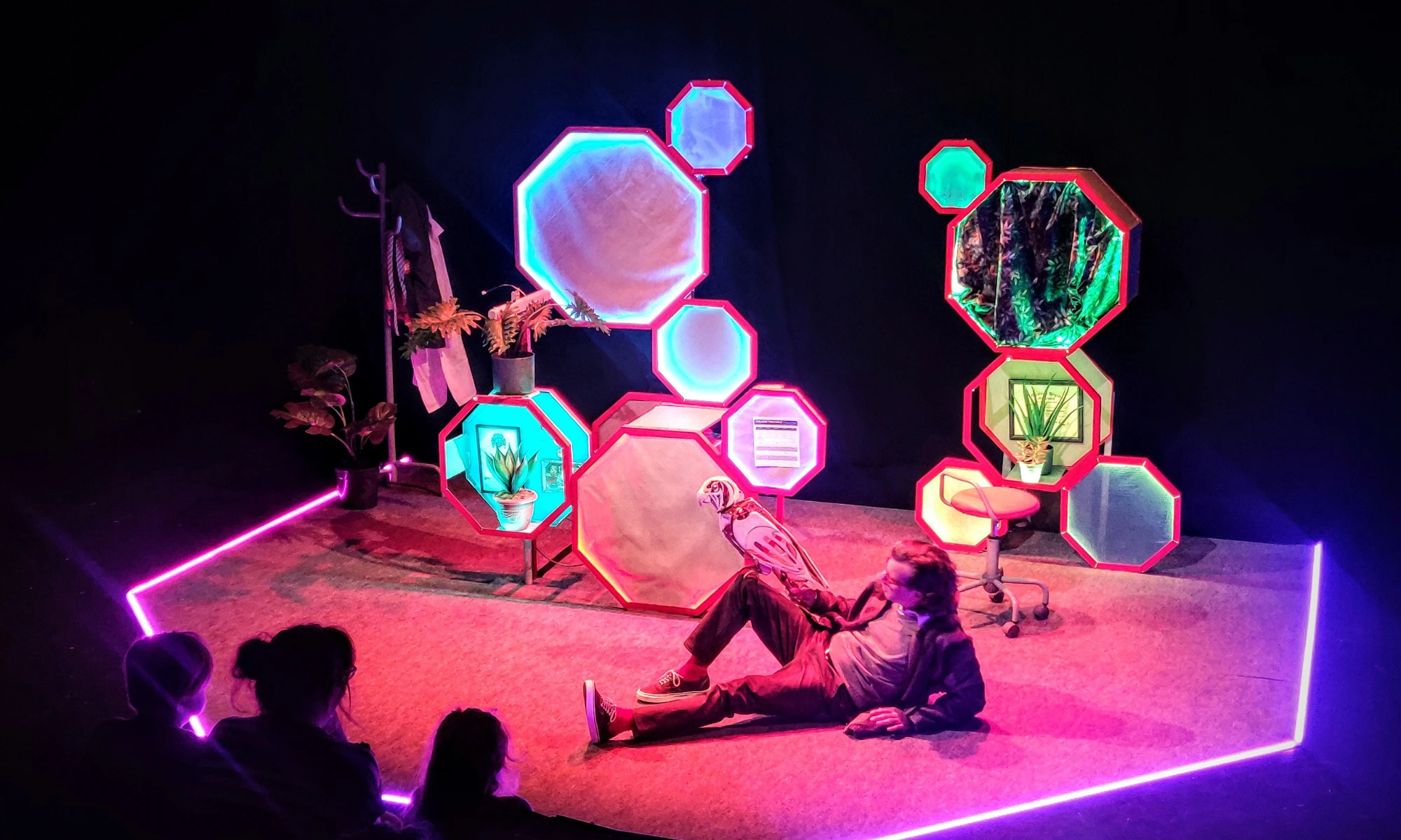 Photo of set with fluorescent lights and actor on stage