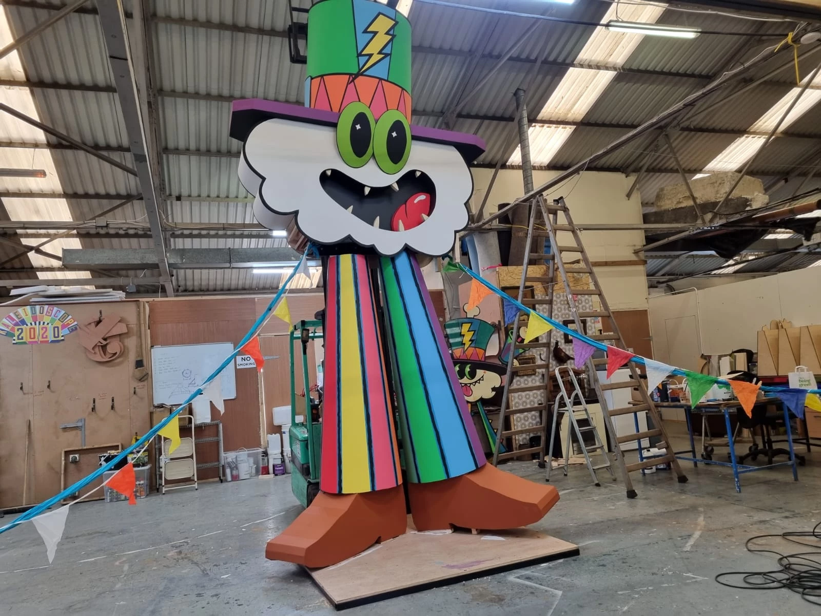 Large-scale colourful sculpture in a studio space.