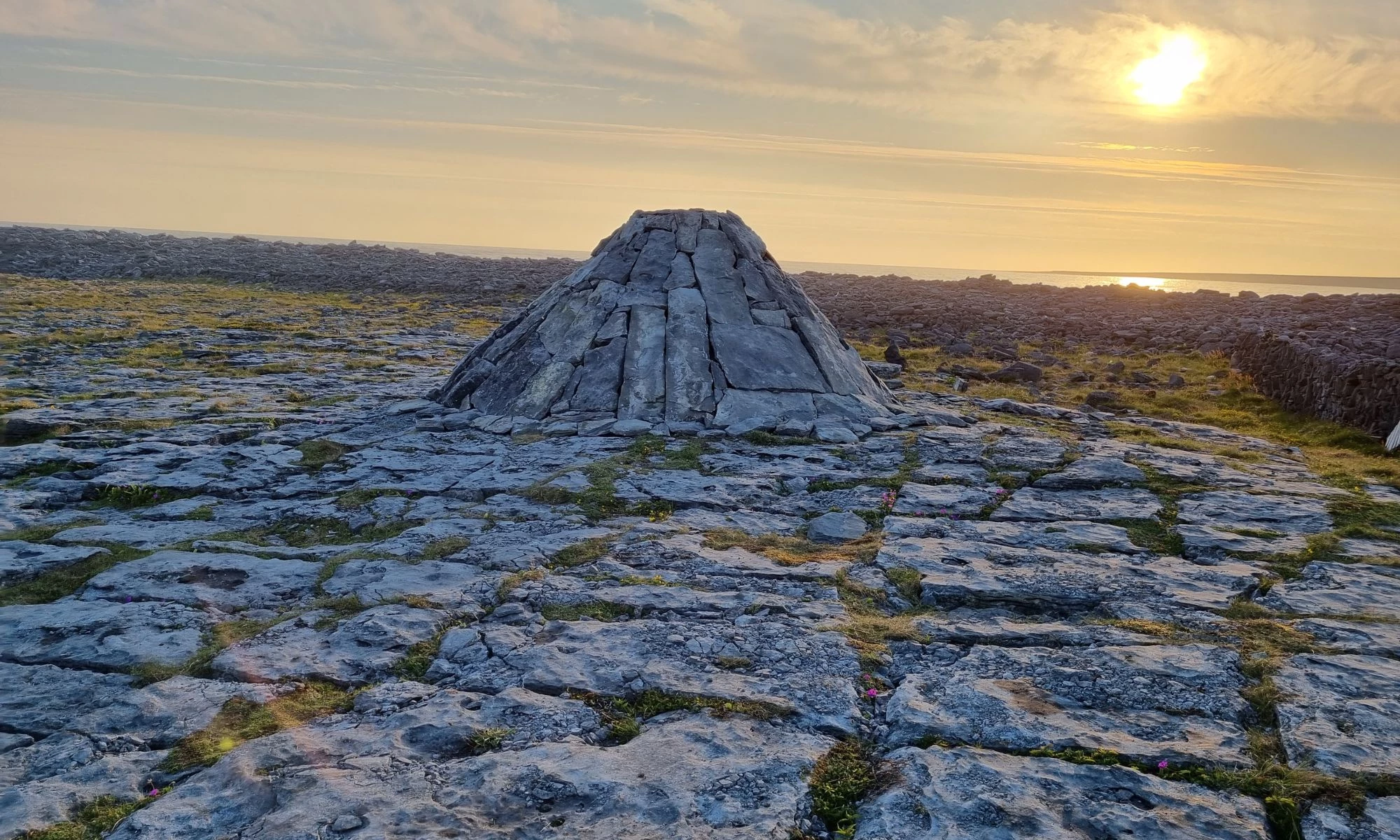 View of conical rocky structure in rockey landscape at sunset. 