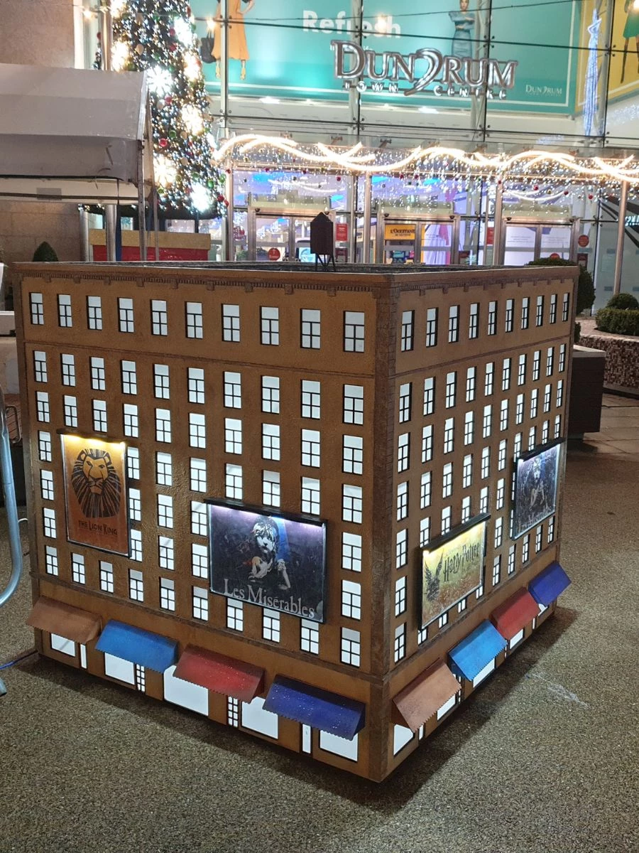 Miniature New York building with theatre billboards.