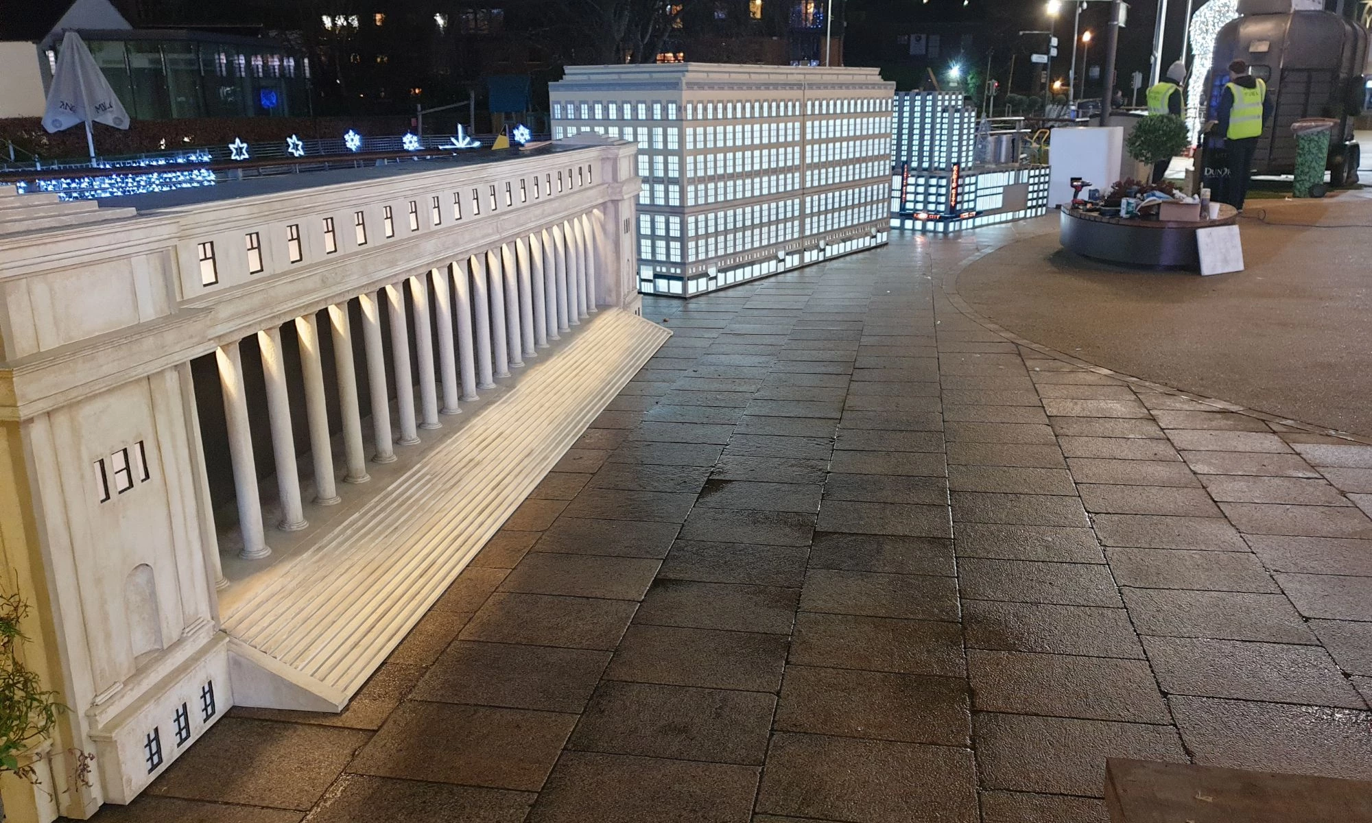 Side view of row of New York buildings, presented in miniature.