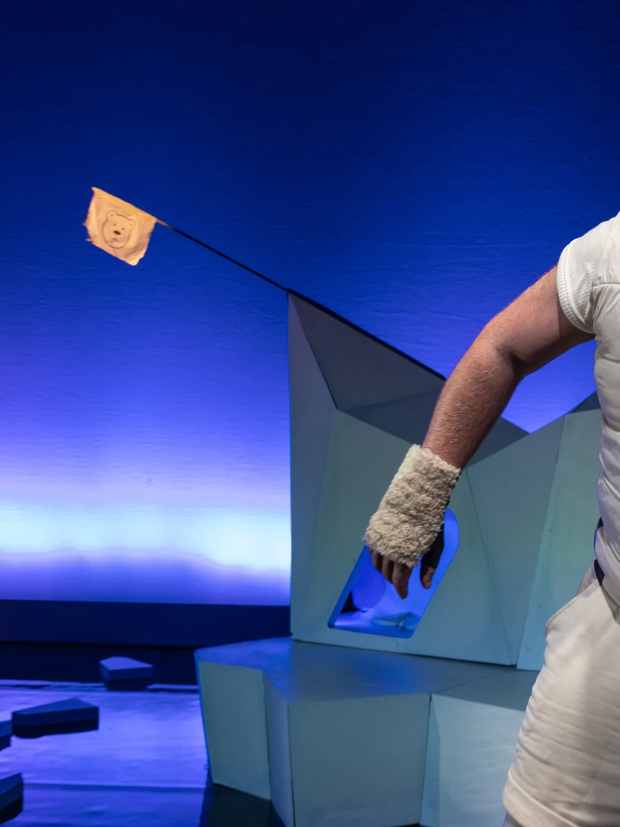 Photo of a stage set with a man exiting out