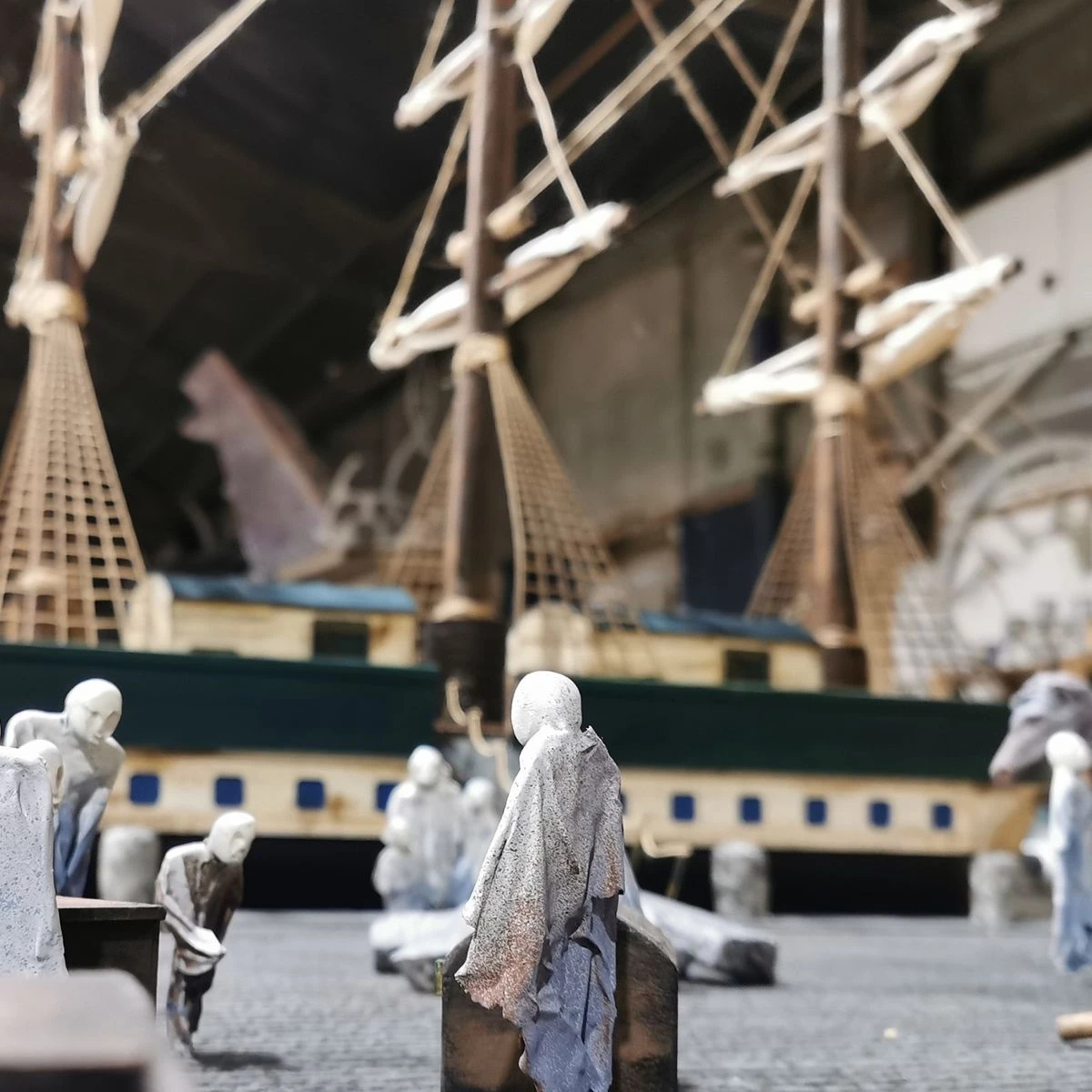 Miniature model of a famine ship and figures.