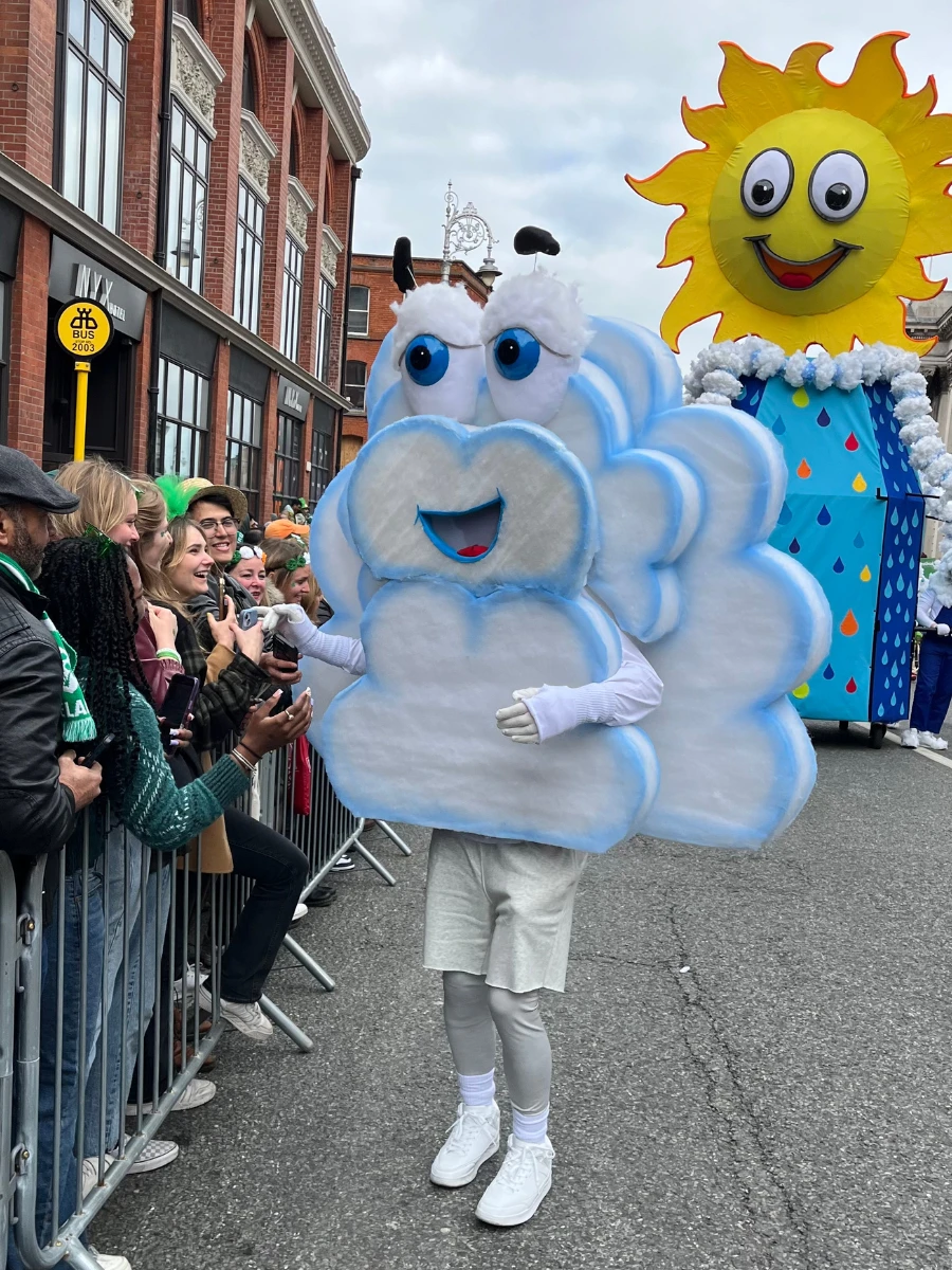 Photo of costumed cloud figure with crowd at St Patricks Day Parade 2025