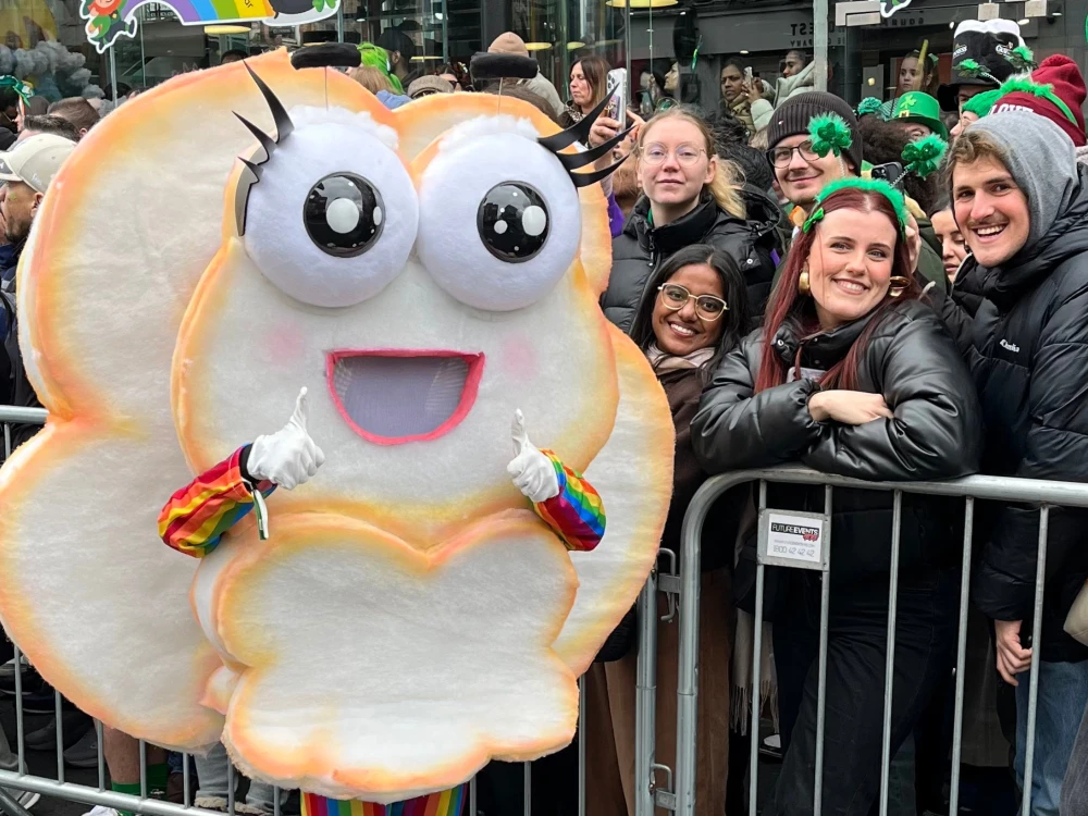 Photo of costumed cloud figure with crowd at St Patricks Day Parade 2025