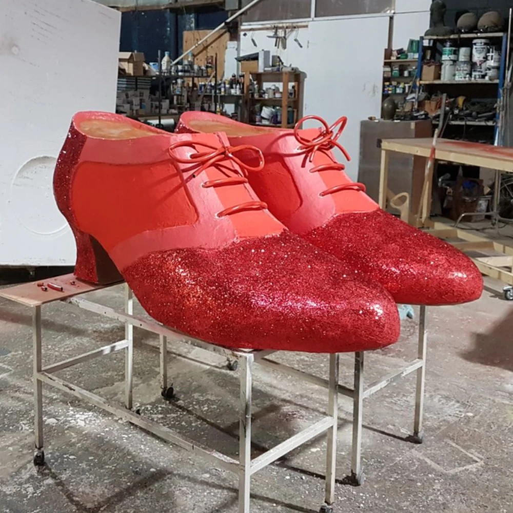 a pair of large scale red shoes